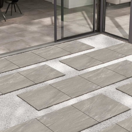 Country Silver Porcelain Paving is now available for delivery and collection at AG Building & Fencing Supplies. The Country Silver Porcelain Paving is scratch-resistant, hard wearing but also a low maintenance paving. This type of porcelain is also known as vitrified paving, it is mixed light grey shades with subtle white undertones. Country Silver Porcelain Paving is also resistant to staining, algae, mould, moss, salts and chemicals. It is maintenance free without the need of sealing. Despite still being hard wearing, long lasting and load resistant, the vitrified porcelain paving range is lighter than traditional paving slabs and is easy to install. It is made using the mixture of refined natural clays and natural pigments of different colours. Specifications: Colour: Grey/Silver Thickness: 20mm Size & Pack Coverage:  900mm x 600mm x 20mm (21.6m²)
